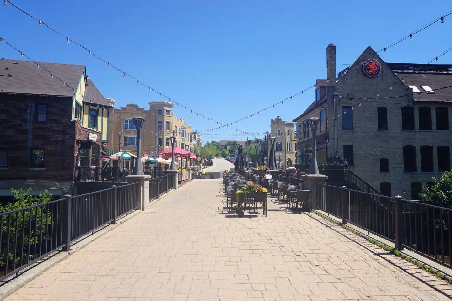 A pedestrian bridge and riverside buildings in Wauwatosa’s village center